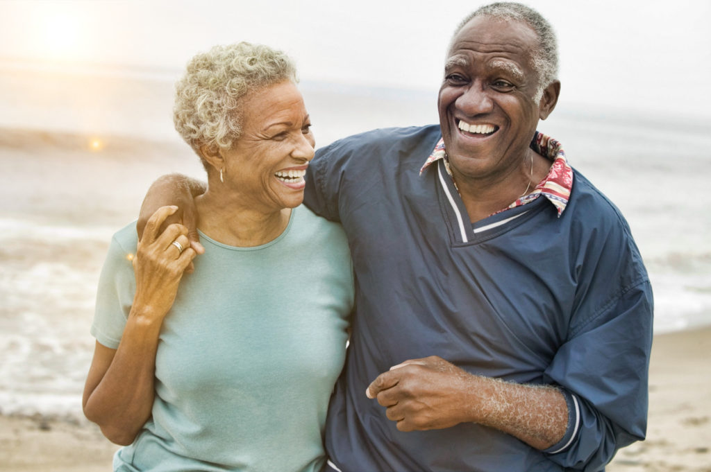 Happy Senior African American Couple on the Beach avoiding Medicare scams