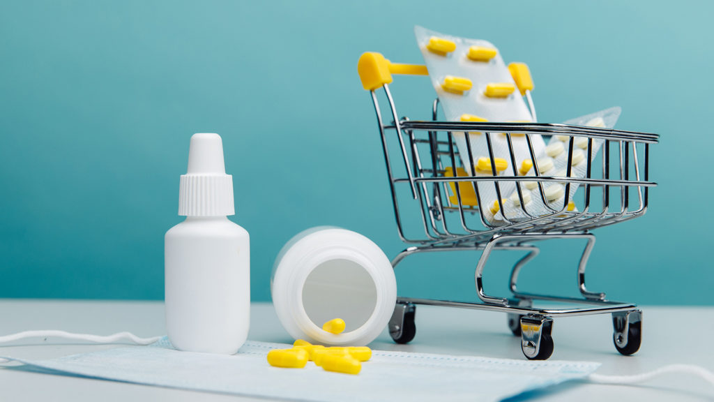 Mini grocery cart with medical goods close-up. Online shopping concept.