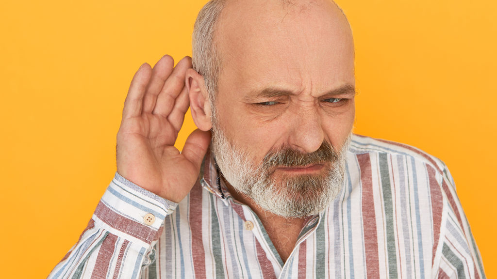 Older man with his hand up to his ear trying to hear the answer to What are special needs plans?