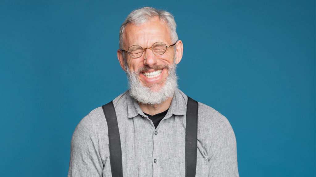 Senior man with a beard smiling because a Local Medicare Agent explained to him how to compare Medigap plans.