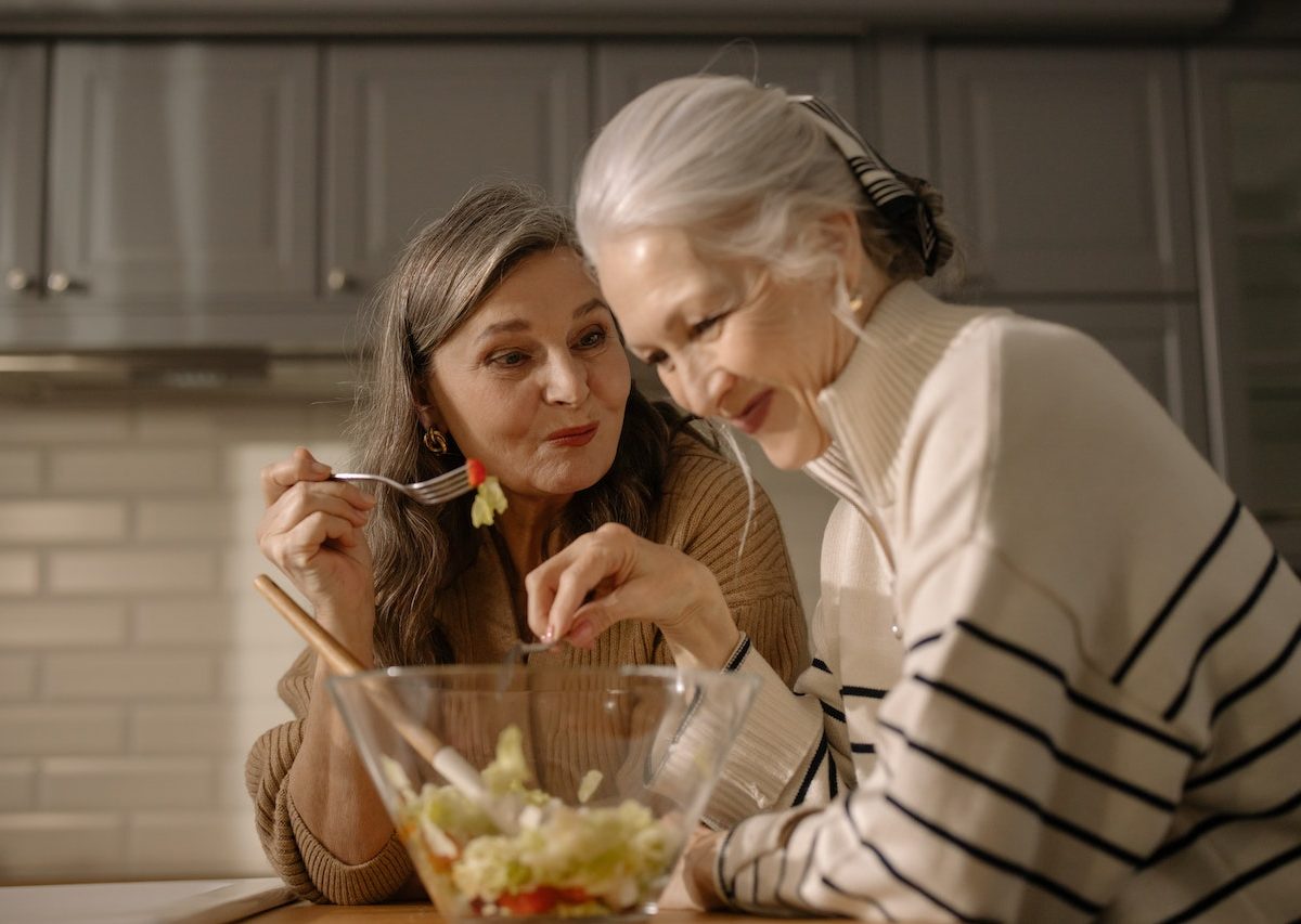 two women eating fruit