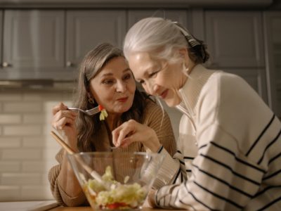 two women eating fruit